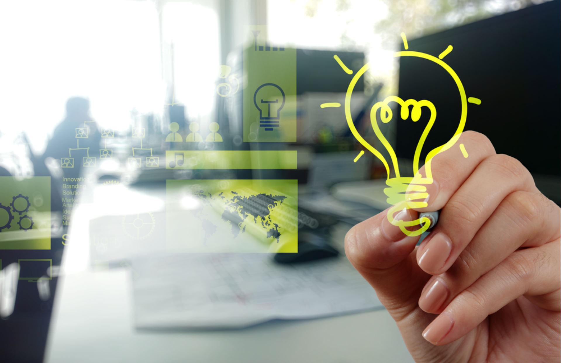 hand drawing a light bulb to symbolize the birth of an idea